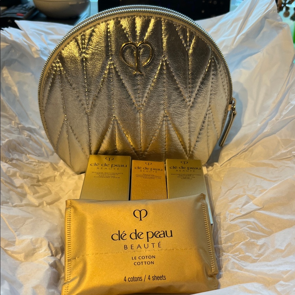 Clé de Peau Silver Cosmetic Bag with Gold Products brand new with cosmetics